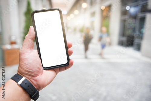 Man holding smart phone with blurred background