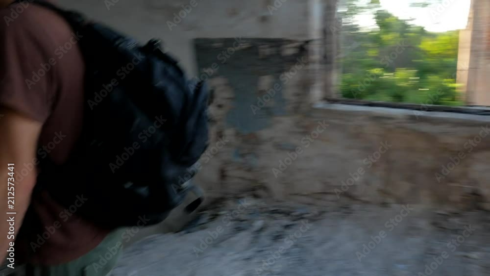 Ranger walks in ruins of abandoned post apocalyptic building Ranger walks in ruins of abandoned post apocalyptic building