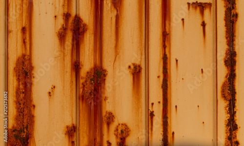 Close up detail of old weathered rusty orange shipping container 