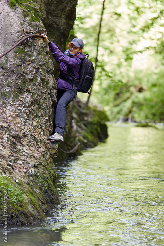 Woman climbing on a mountain wall