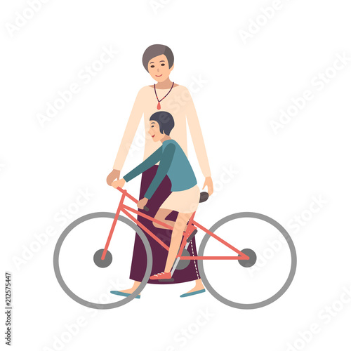 Mom teaching daughter ride bicycle. Mother showing little girl how to pedal b...