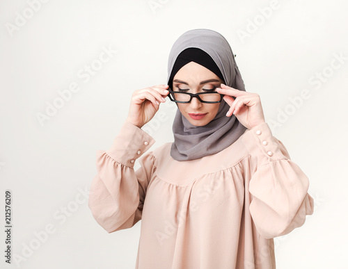 Trendy eastern woman in hijab and glasses