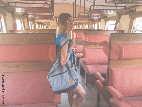 Girl with rucksack inside the old retro wagon.
