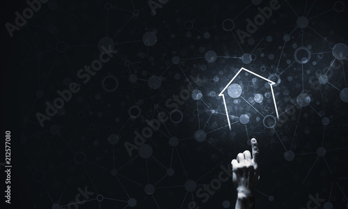 Conceptual image with hand pointing at house or main page icon o © adam121