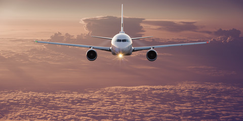 Commercial airplane flying above clouds.