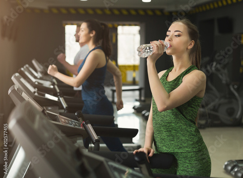 Attractive woman on treadmill in fitness club