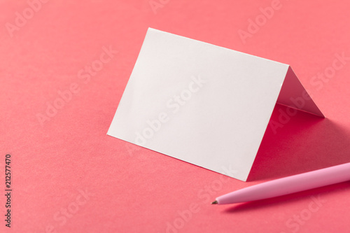 Blank paper pieces  on a colored pink background