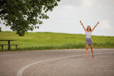 Girl enjoying on a empty suburb road.