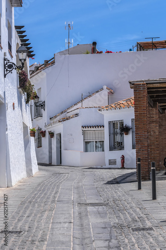 Beautiful view of Mijas Picturesque Narrow Street. Mijas - Spanish hill town overlooking the Costa del Sol, not far from Malaga. Mijas known for its white-washed buildings. Mijas, Andalusia, Spain. photo