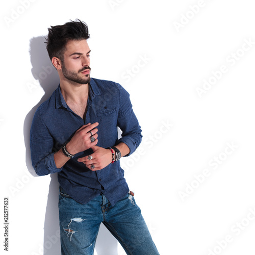 attractive man in navy shirt looking down to side