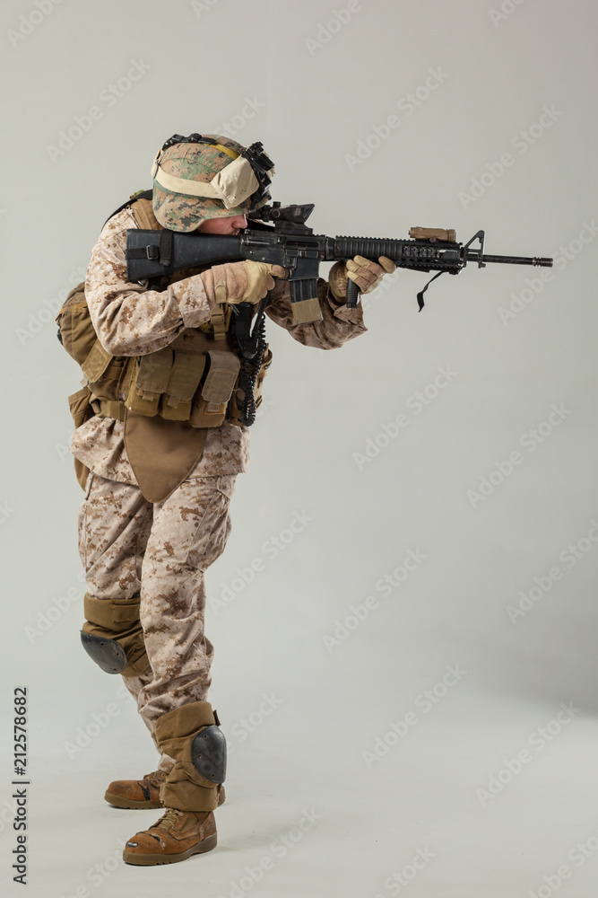 Soldier in camouflage holding rifle Soldier in camouflage holding rifle