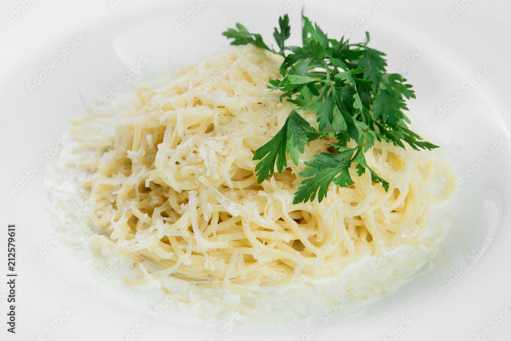 Pasta with parmesan on white plate on a black wooden background. Pasta with parmesan on white plate on a black wooden background.