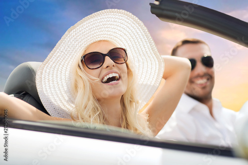 road trip, travel and people concept - happy couple driving in convertible car over sky background © Syda Productions