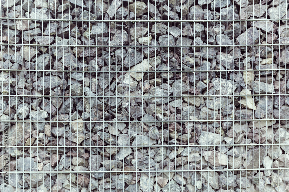 Fototapeta premium fence from the pieces of granite and metallic grates