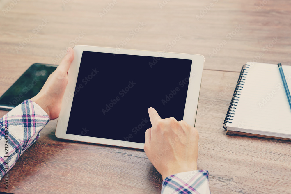 Asia woman using tablet on table in coffee shop. vintage toned. Asia woman using tablet on table in coffee shop. vintage toned.