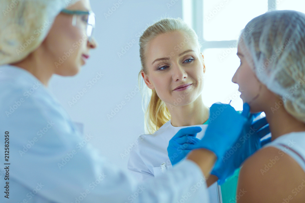 Beautiful woman face near doctor with syringe. Beautiful woman face near doctor with syringe.