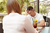 Couple having relationship problems, talking in a cafe