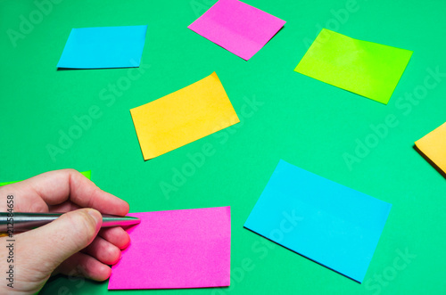 sticky stickers for notes on a green background. time management, creative new idea. bad memory. reminder