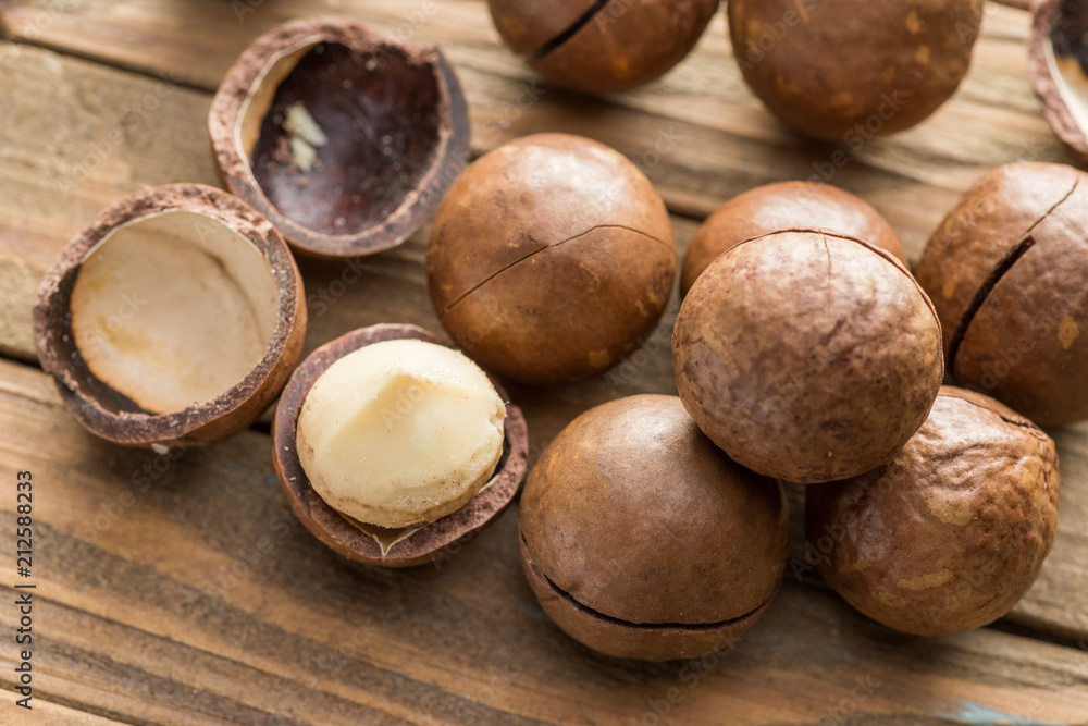 Macadamia nuts or bush nuts on the wooden table. Macadamia nuts or bush nuts on the wooden table.