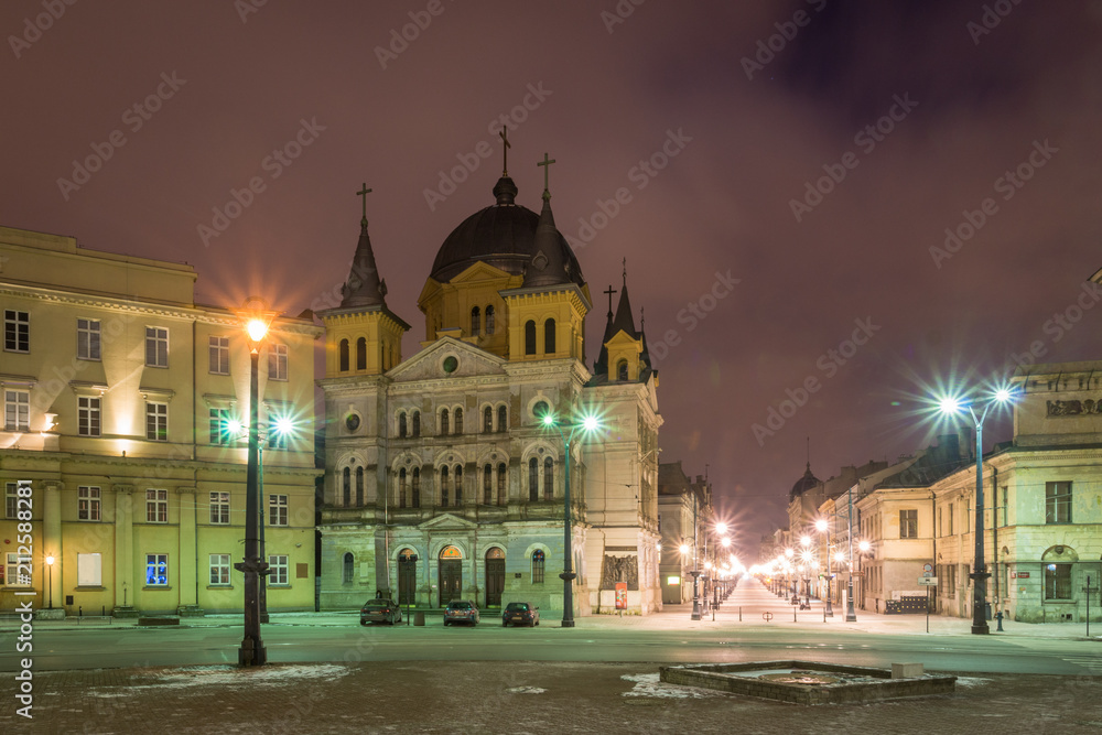 Fototapeta premium Church at Piotrkowska street at night in Lodz city, Lodzkie, Poland