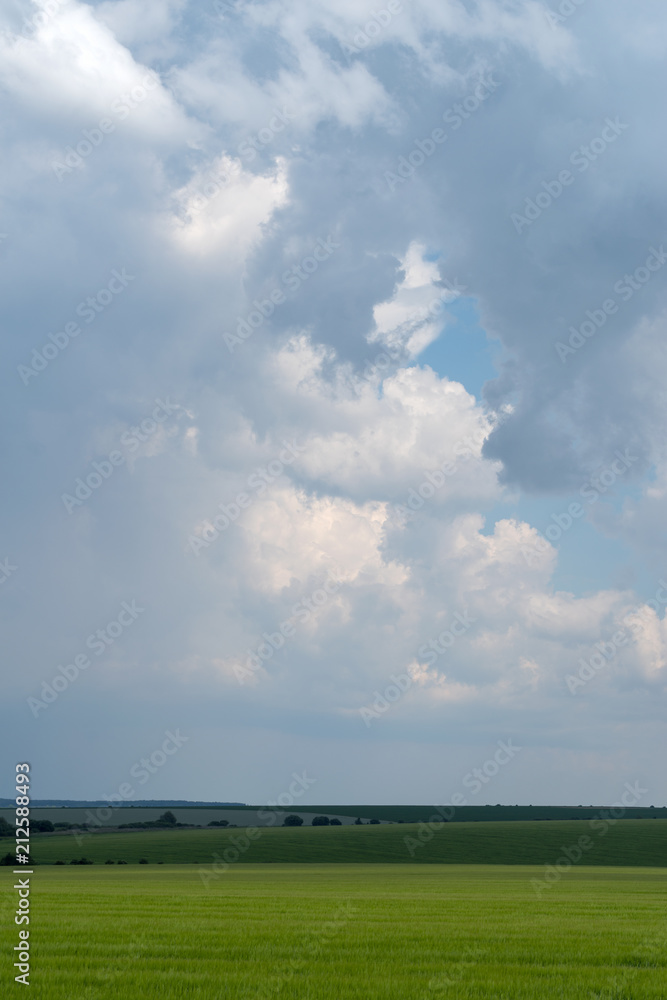 Podolia region, Ukraine. Landscape with dramatic clouds over agricultural field