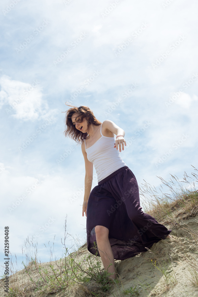 Woman in a skirt is running from the mountain
Woman in a skirt is running from the mountain