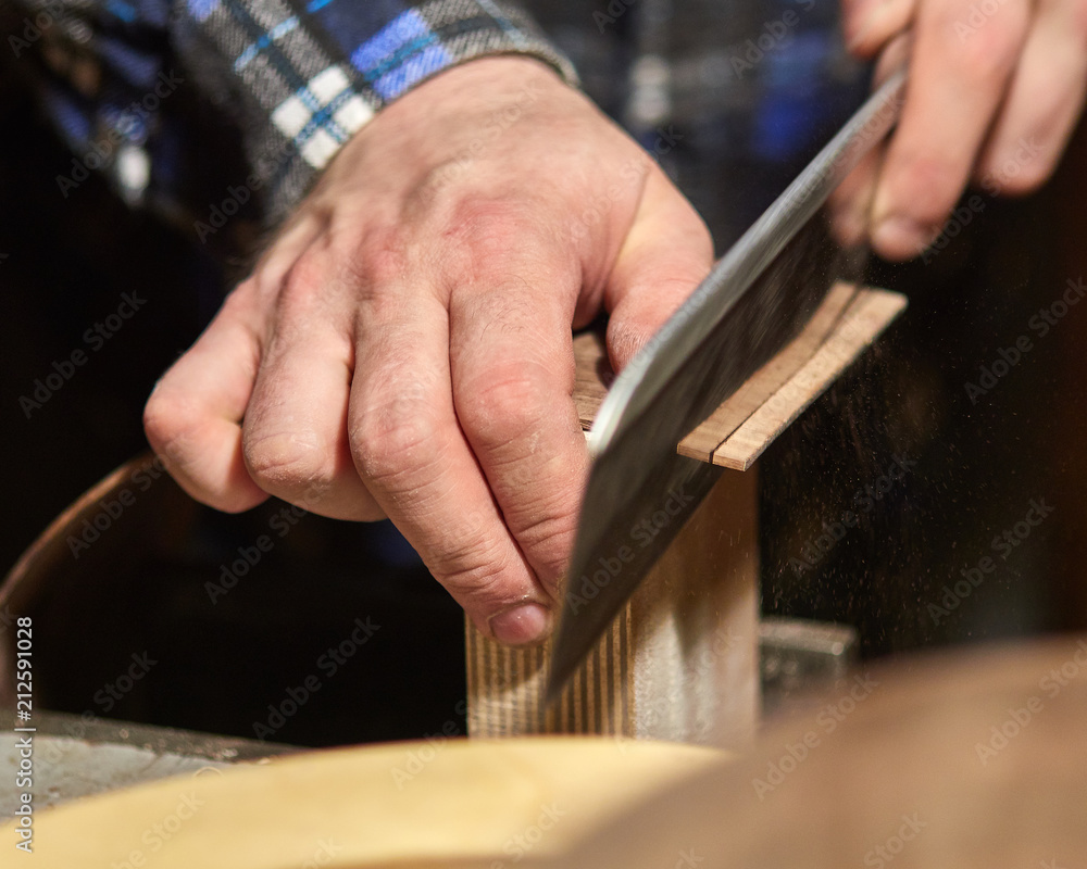 The process of making a classical guitar. Adjust the sides of the guitar to fit.
