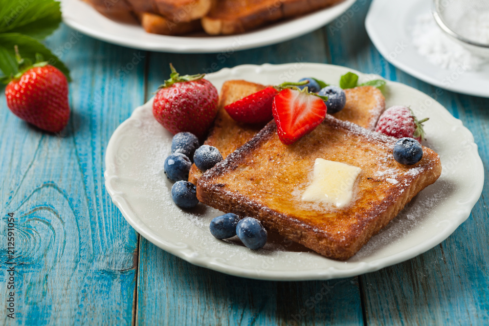 Traditional, delicious, sweet French toast with fruit and butter. Traditional, delicious, sweet French toast with fruit and butter.