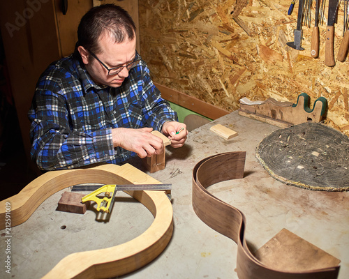 The process of making a classical guitar. Preparing to install the neckblock. photo