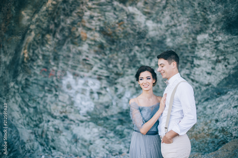 Beautiful couple near the rocks, wedding Beautiful couple near the rocks, wedding