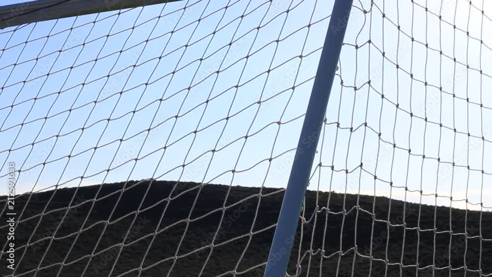 Pan of an empty soccer net with the morning sun. Pan of an empty soccer net with the morning sun.