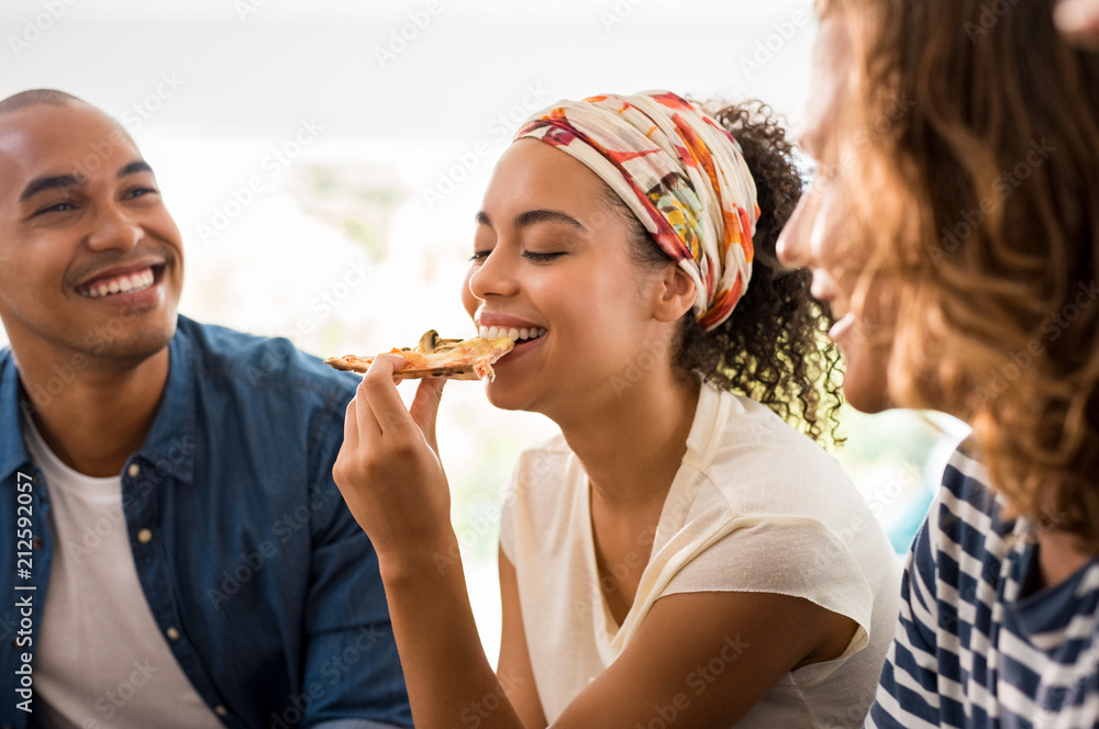 Woman enjoying pizza with friends