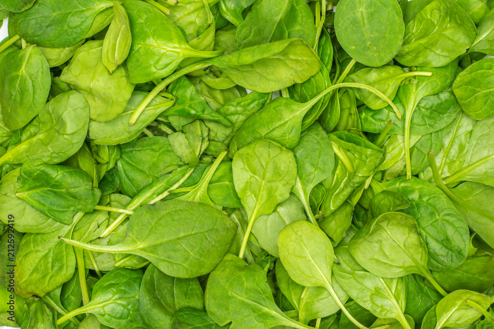 Fresh baby spinach leaves background top view. Fresh baby spinach leaves background top view.