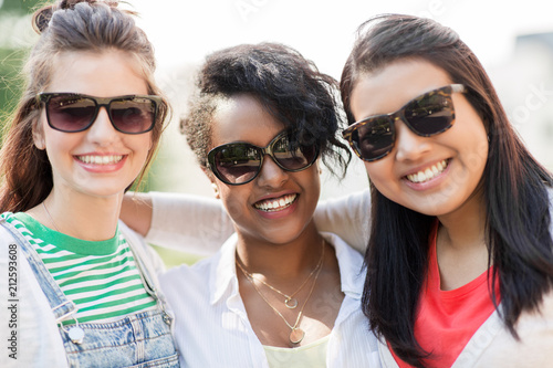female friendship  summer and eyewear - happy young women in sunglasses outdoors