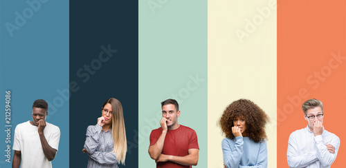 Group of people over vintage colors background looking stressed and nervous with hands on mouth biting nails. Anxiety problem.