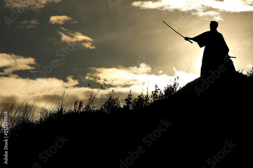Silhouette black and white photo warrior with sword on the mountain