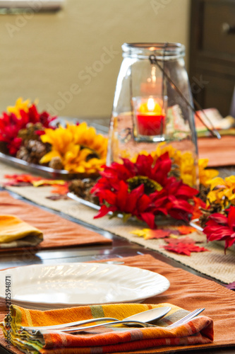 A table set for a fall feast with the focus on the foreground.