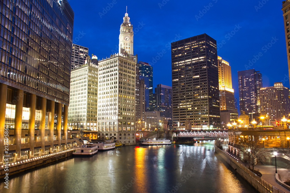 Fototapeta premium The Chicago River in the evening during the Blue Hour with plenty of city lights.