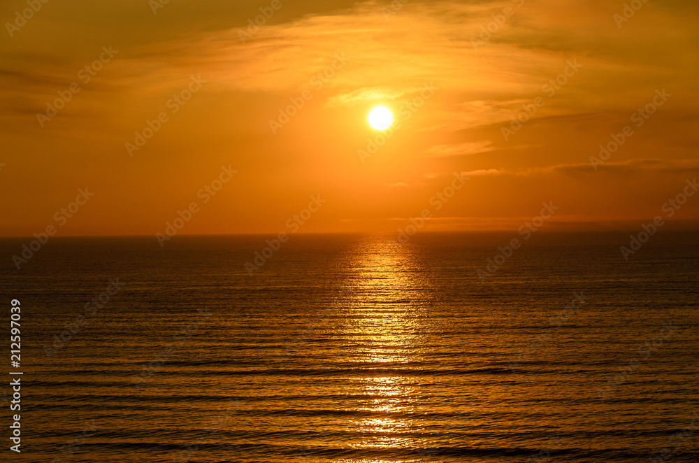 Beach of Black Sea from Mamaia, Romania with golden orange sky, sands and blue clear water, sunrise
