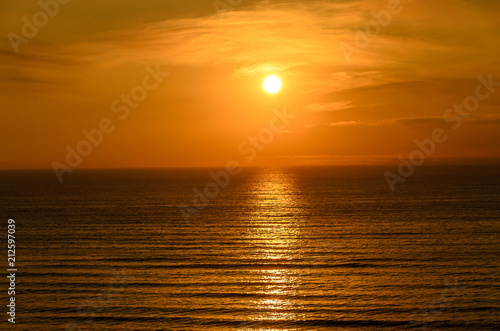 Beach of Black Sea from Mamaia  Romania with golden orange sky  sands and blue clear water  sunrise