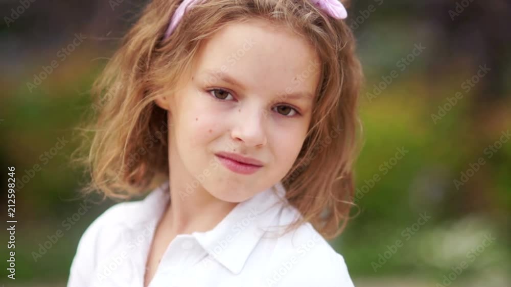 Portrait in a half-turn. The girl looks at the camera over her shoulder, a calm, friendly look. Young coquette Portrait in a half-turn. The girl looks at the camera over her shoulder, a calm, friendly look. Young coquette