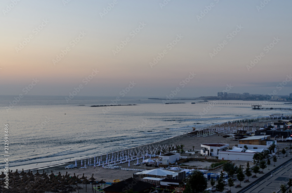 MAMAIA, ROMANIA - SEPTEMBER 15, 2017: Seafront and promenade of  Black Sea with bars and hotels at sunrise time
