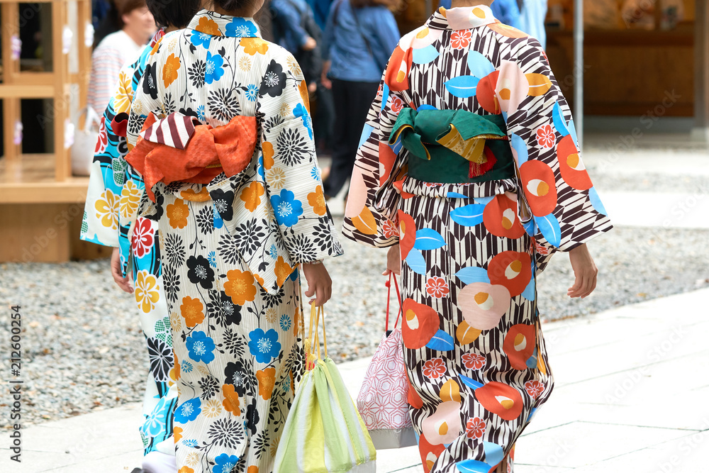 Young girl wearing Japanese kimono standing in front of Sensoji Temple in Tokyo, Japan. Kimono is a Japanese traditional garment. The word Young girl wearing Japanese kimono standing in front of Sensoji Temple in Tokyo, Japan. Kimono is a Japanese traditional garment. The word
