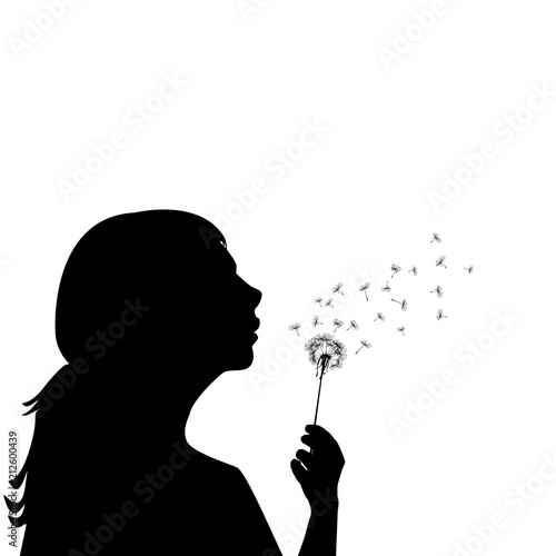Silhouette of a little girl blowing dandelion