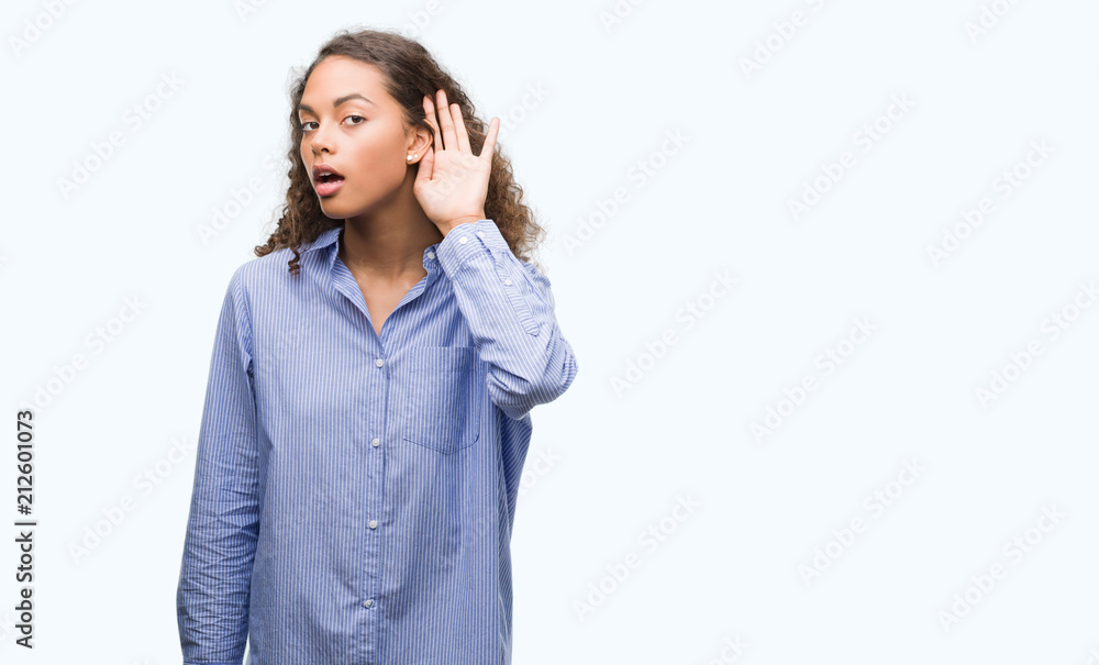 Young hispanic business woman smiling with hand over ear listening an hearing to rumor or gossip. Deafness concept. Young hispanic business woman smiling with hand over ear listening an hearing to rumor or gossip. Deafness concept.