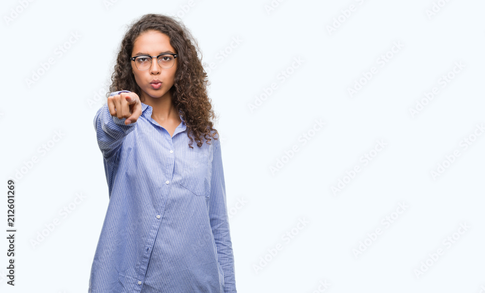 Beautiful young hispanic woman wearing glasses pointing with finger to the camera and to you, hand sign, positive and confident gesture from the front Beautiful young hispanic woman wearing glasses pointing with finger to the camera and to you, hand sign, positive and confident gesture from the front