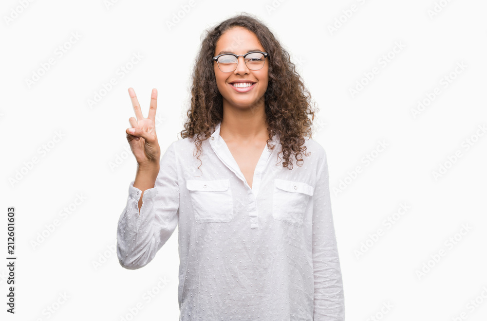Beautiful young hispanic woman showing and pointing up with fingers number two while smiling confident and happy. Beautiful young hispanic woman showing and pointing up with fingers number two while smiling confident and happy.