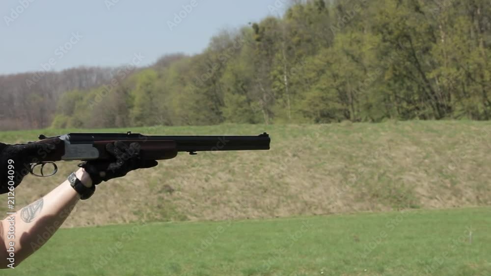 A man with double-barreled rifle. The man in glasses targets with a rifle A man with double-barreled rifle. The man in glasses targets with a rifle