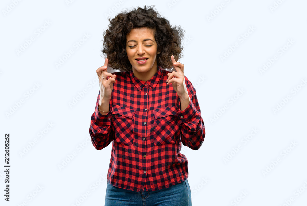 Beautiful arab woman with crossed fingers asking for good luck Beautiful arab woman with crossed fingers asking for good luck
