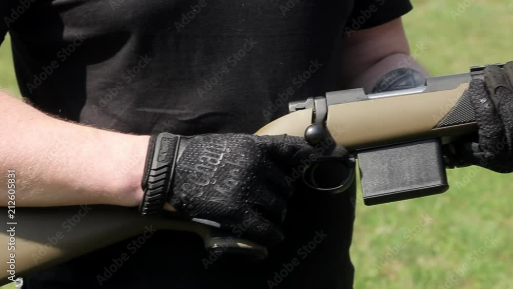 A close up panorama view of carbine. Man's hand hold a carbine A close up panorama view of carbine. Man's hand hold a carbine